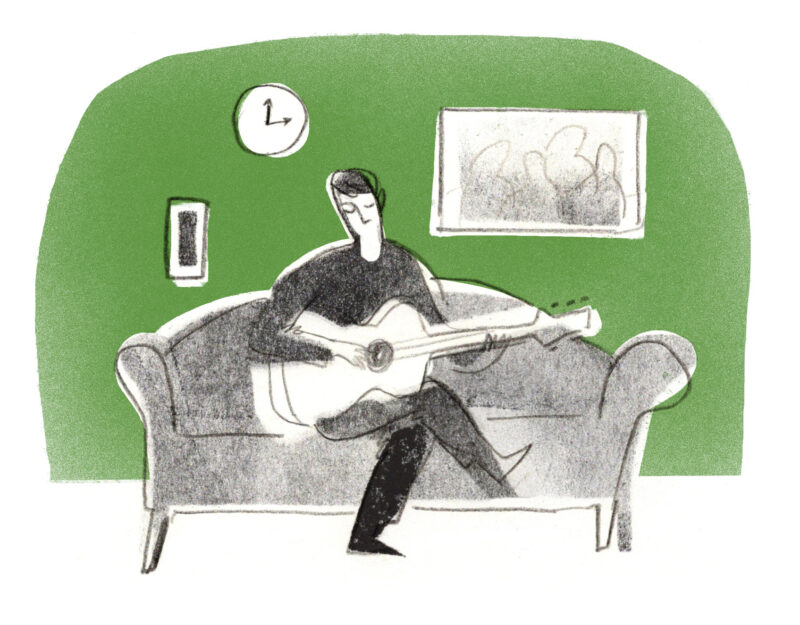 A person playing guitar on a sofa against a green background