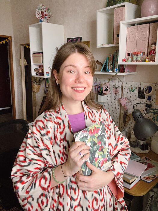Anna Fedoseeva holding copies of a magazine