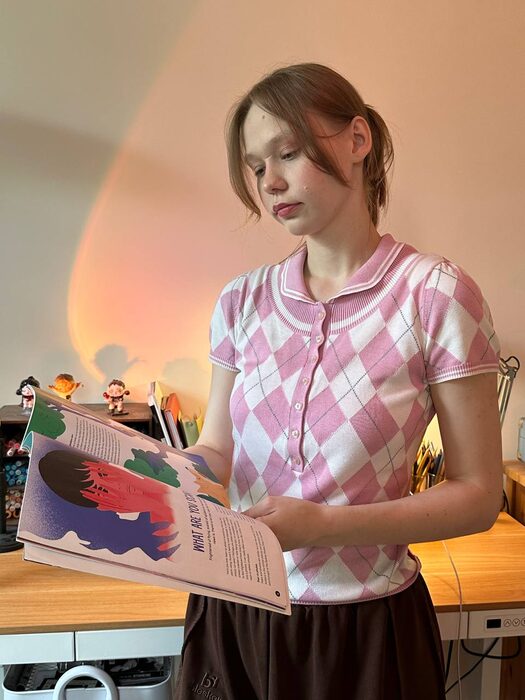 Liza Rylskaya looking through an illustrated book
