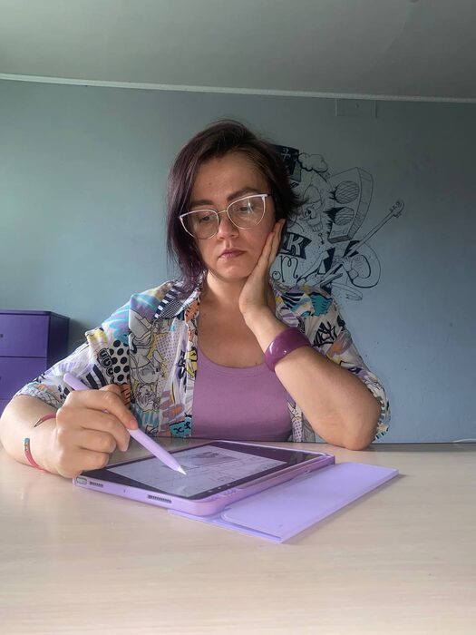 Anastasia Teslia drawing at her desk