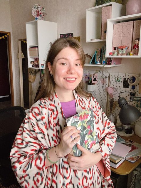 Anna Fedoseeva holding copies of a magazine